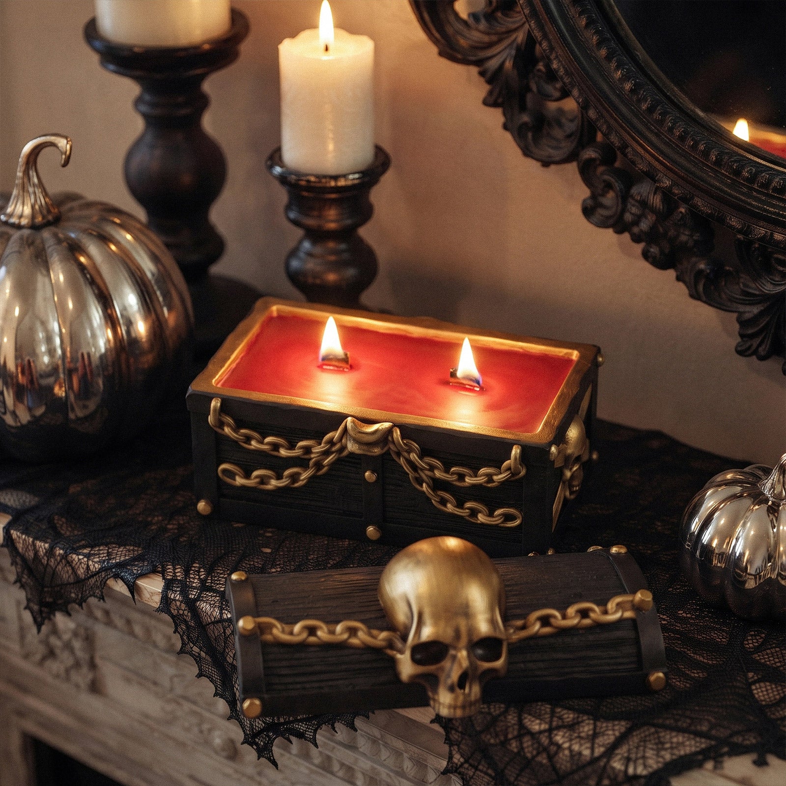 Lit red wax skull treasure chest candle jar paired with matching lid, styled with silver pumpkins and vintage candlesticks - Boowan Nicole