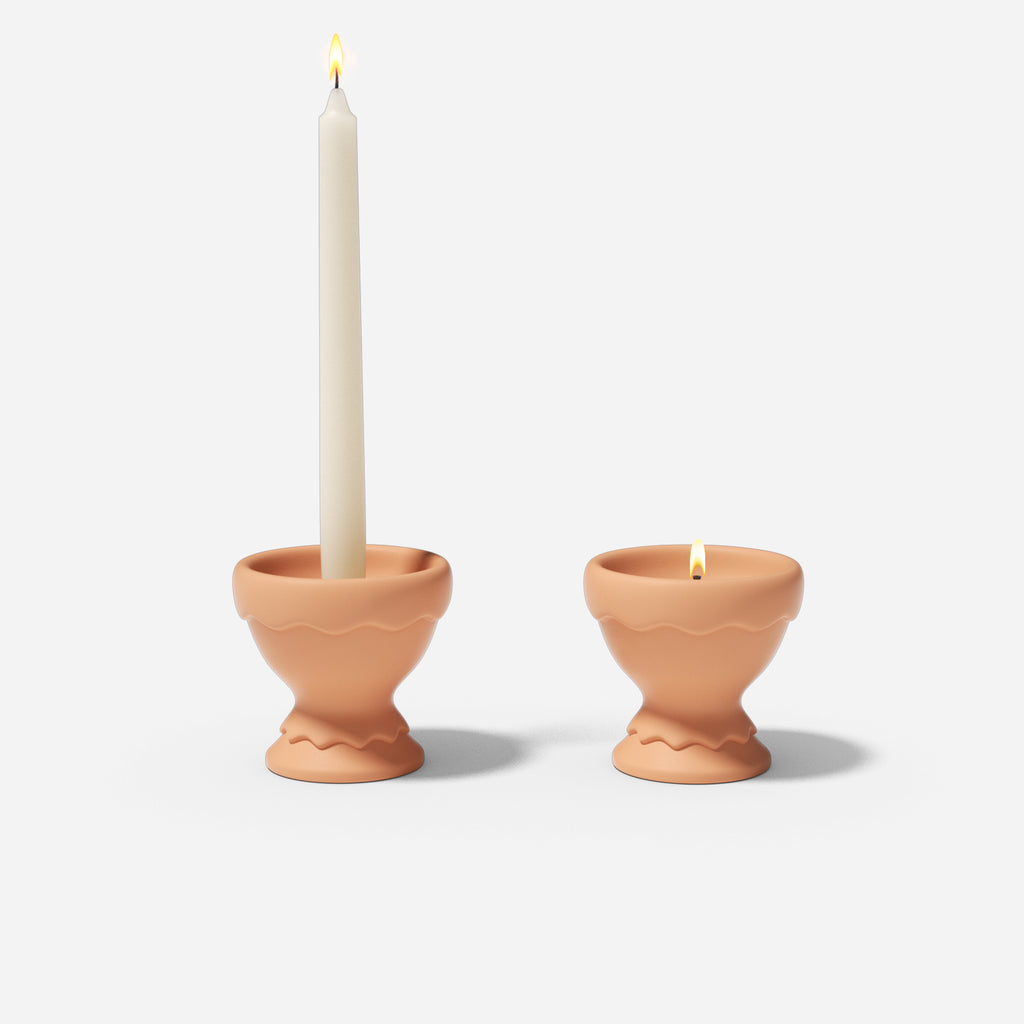  Illuminated Eggshell Cup Shape Candle Holders adorned with lit taper candles and tea light candles create a captivating display.