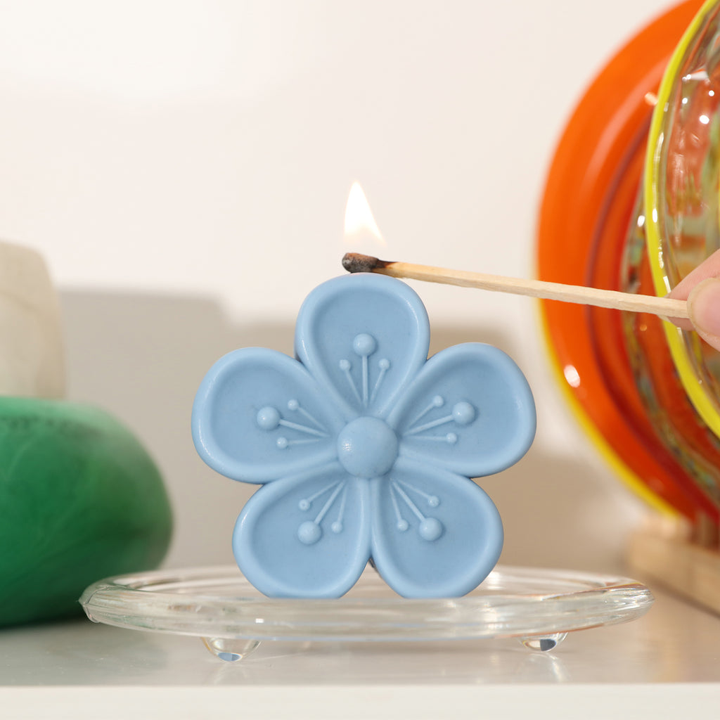 Use a match to light the blue Peach Blossom Candle on the crystal tray - Boowan Nicole
