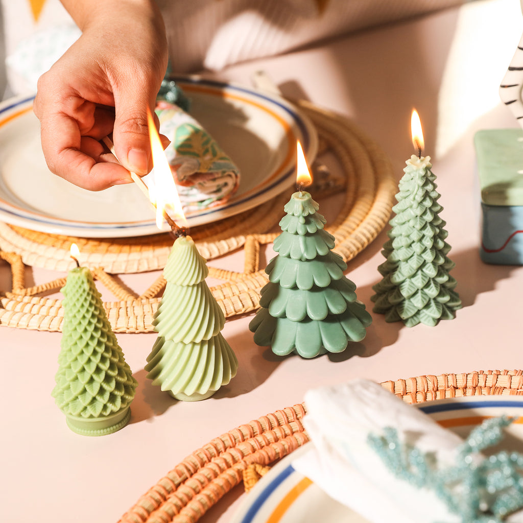 Four Christmas tree candles of different shapes placed on the dining table were lit in sequence.