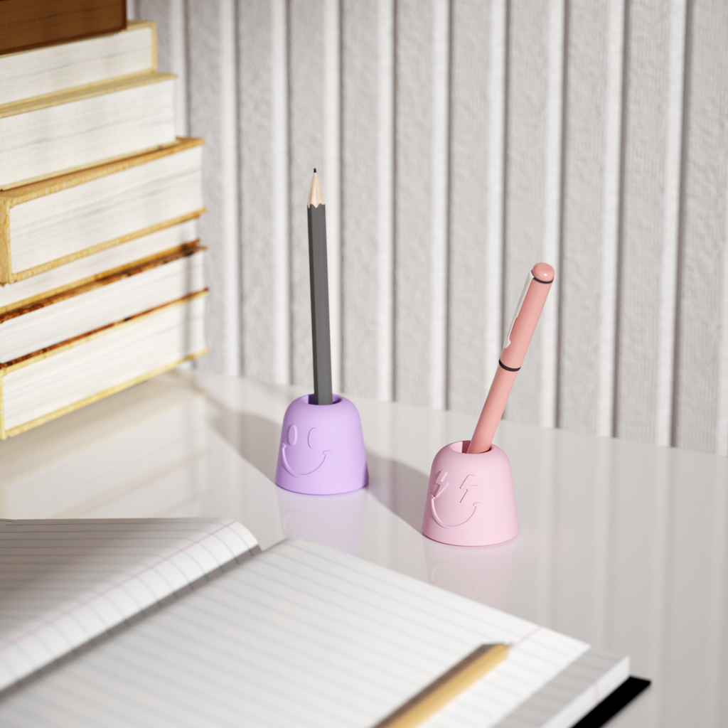 Purple and pink Pen & Toothbrush Holders are placed on the table with a pen inserted in each - Boowan Nicole