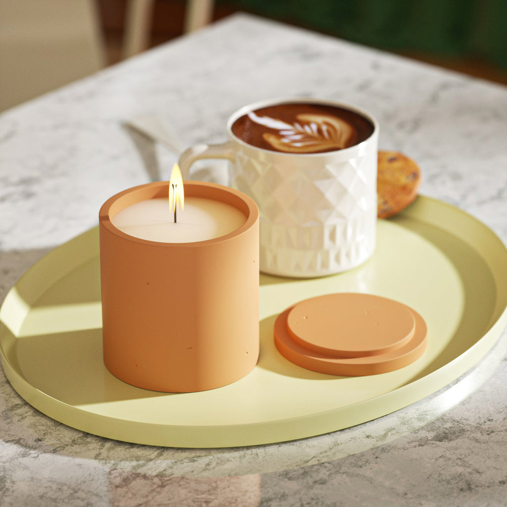 A dancing flame in the candle jar, a cup of coffee on a tray—creating an artistic ambiance.
