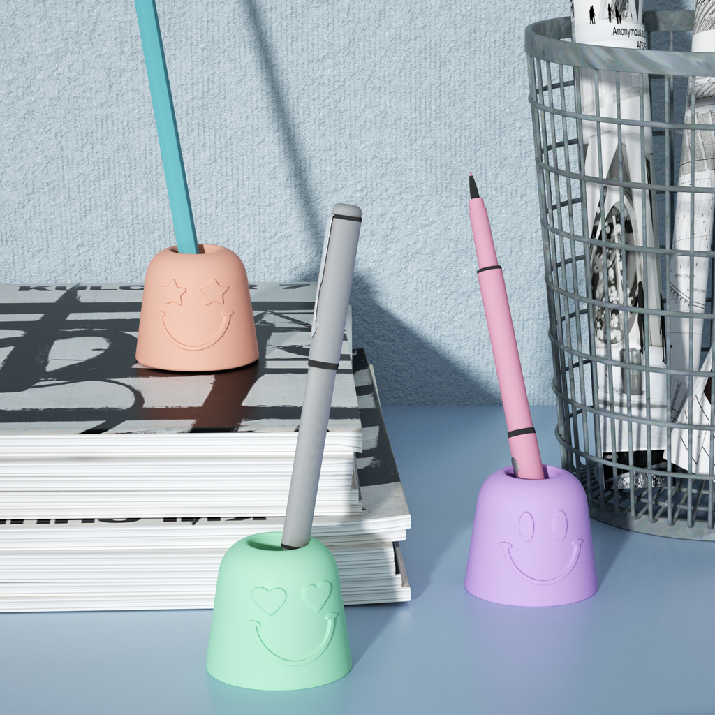 Pen & Toothbrush Holder in three colors of purple, green and pink are placed on the desktop and book respectively-Boowan Nicole