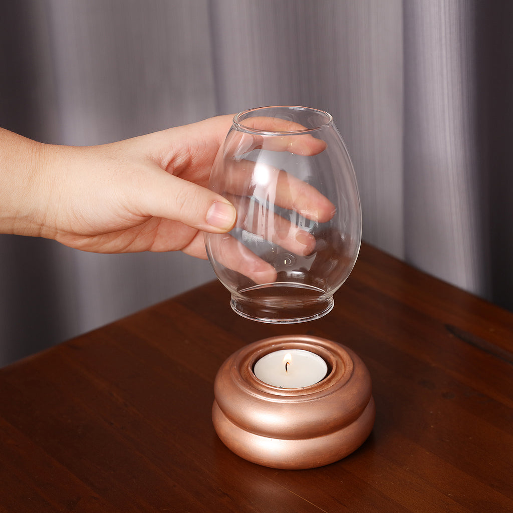 Carefully placing the glass cover on the shiny tealight candle holder