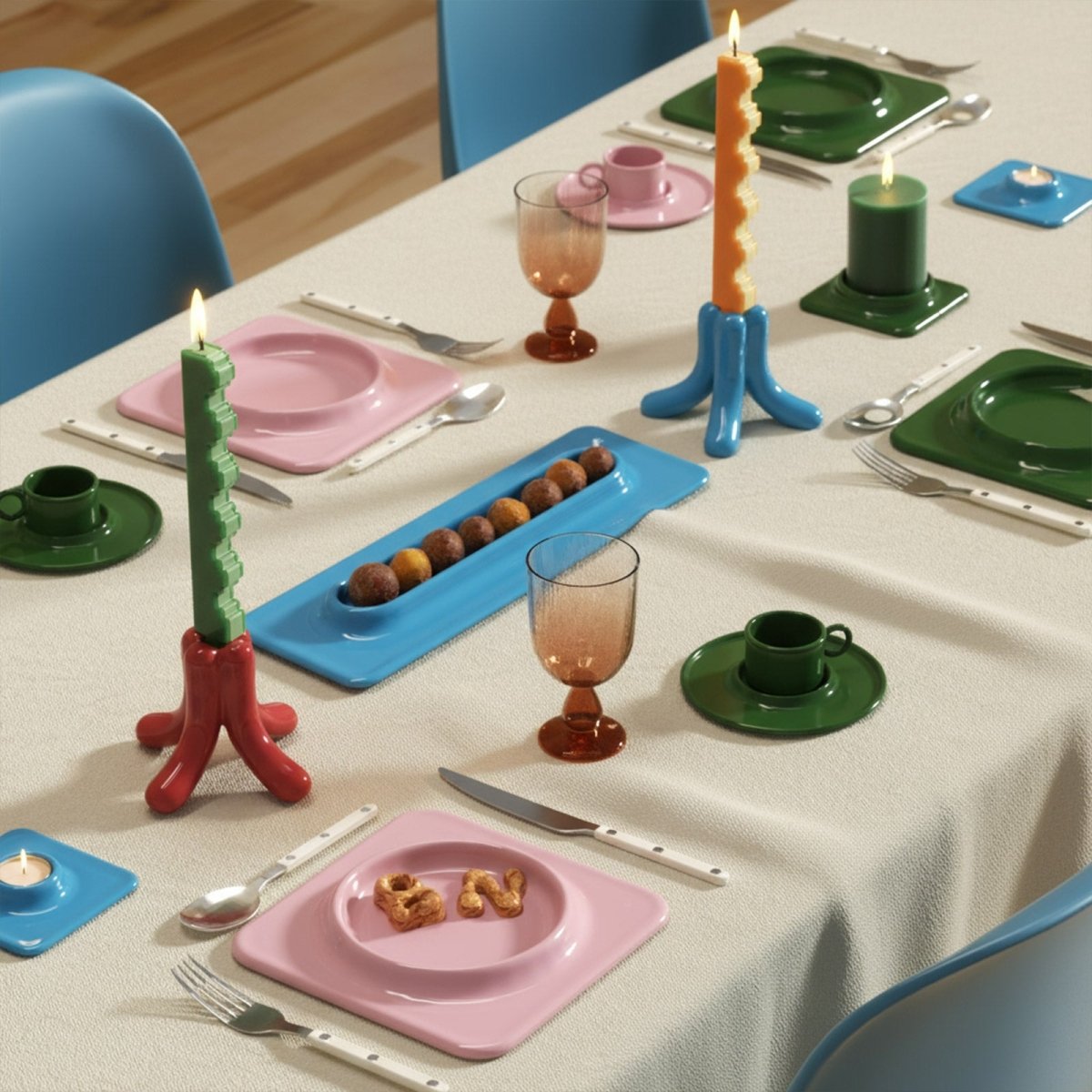 Stair-step taper candles in blue and red holders on a colorful dining table - Boowan Nicole