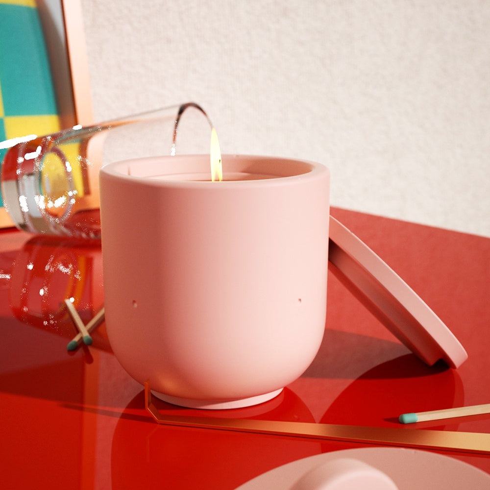 Boowannicole's pink candle jar, aglow on the table, radiating warmth and elegance.