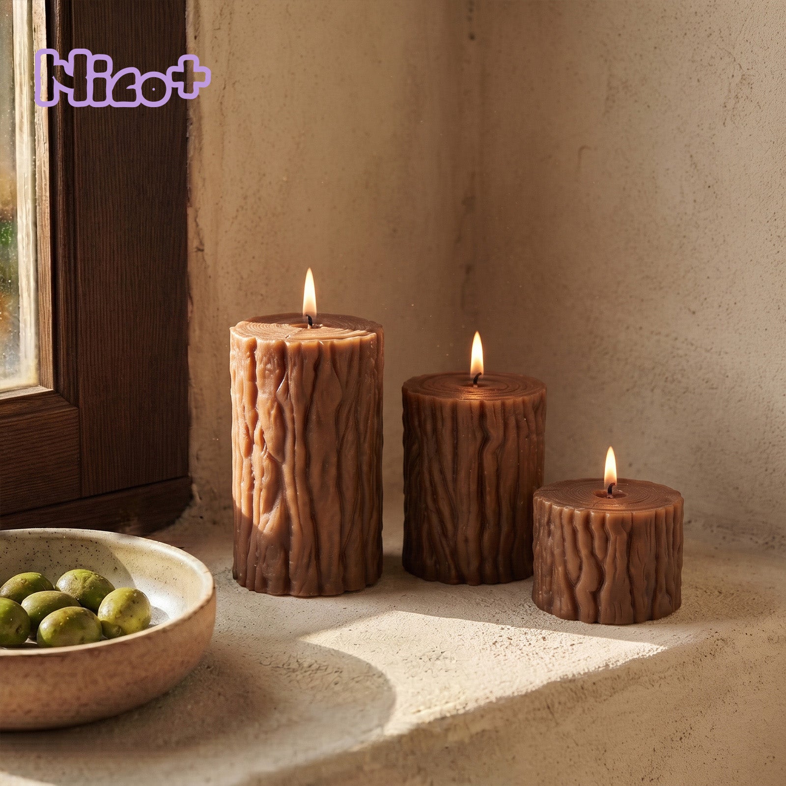 Trio of lit forest stump pillar candles with realistic bark texture and tree ring tops, warm rustic window styling - Boowan Nicole