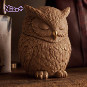 Close‑up shot of gilded finished owl candle jar with detailed feather textures and golden trim - Boowan Nicole