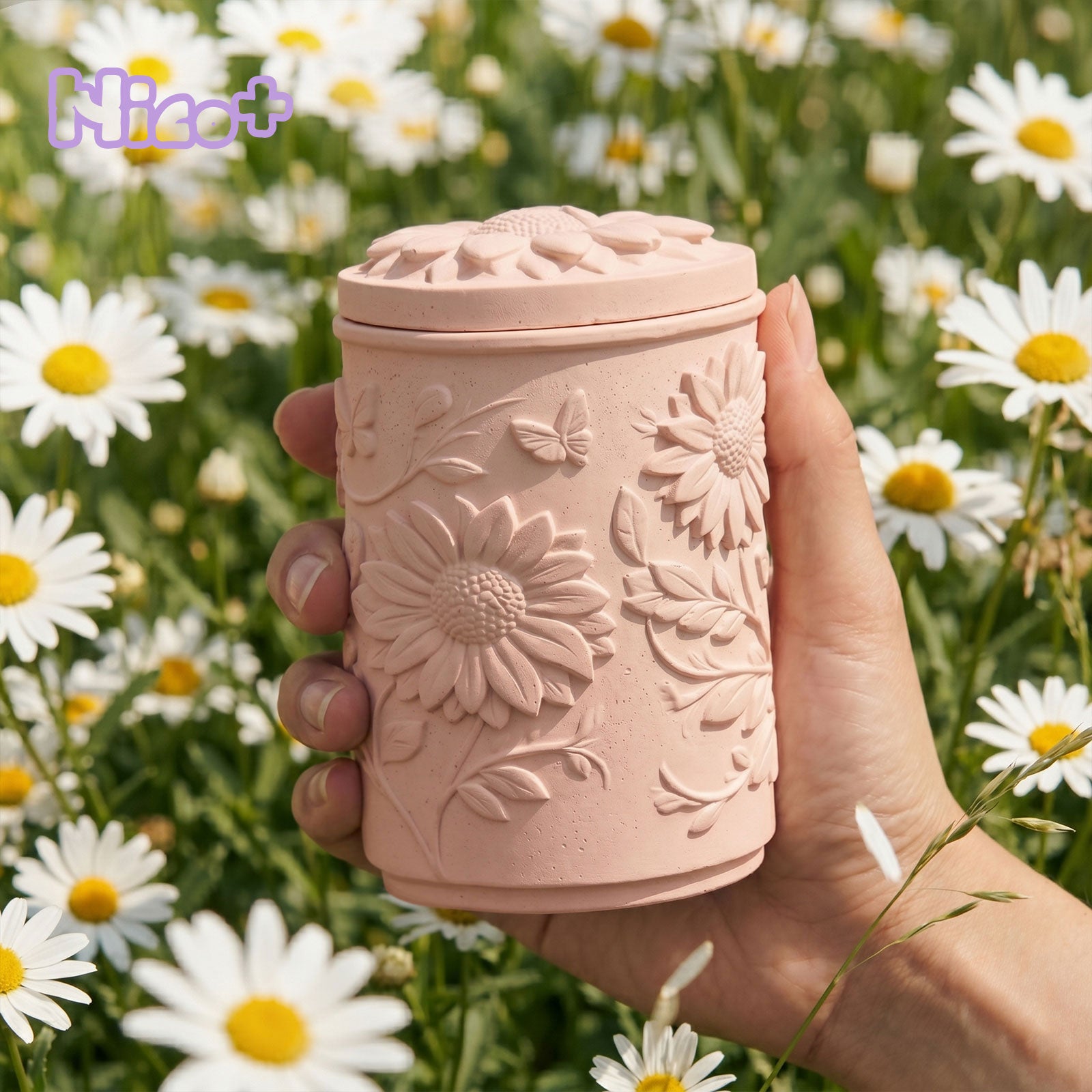 Sunflower Embossed Candle Jar Silicone Mold, finished pink candle jar with lid held in hand, daisy background - Boowan Nicole