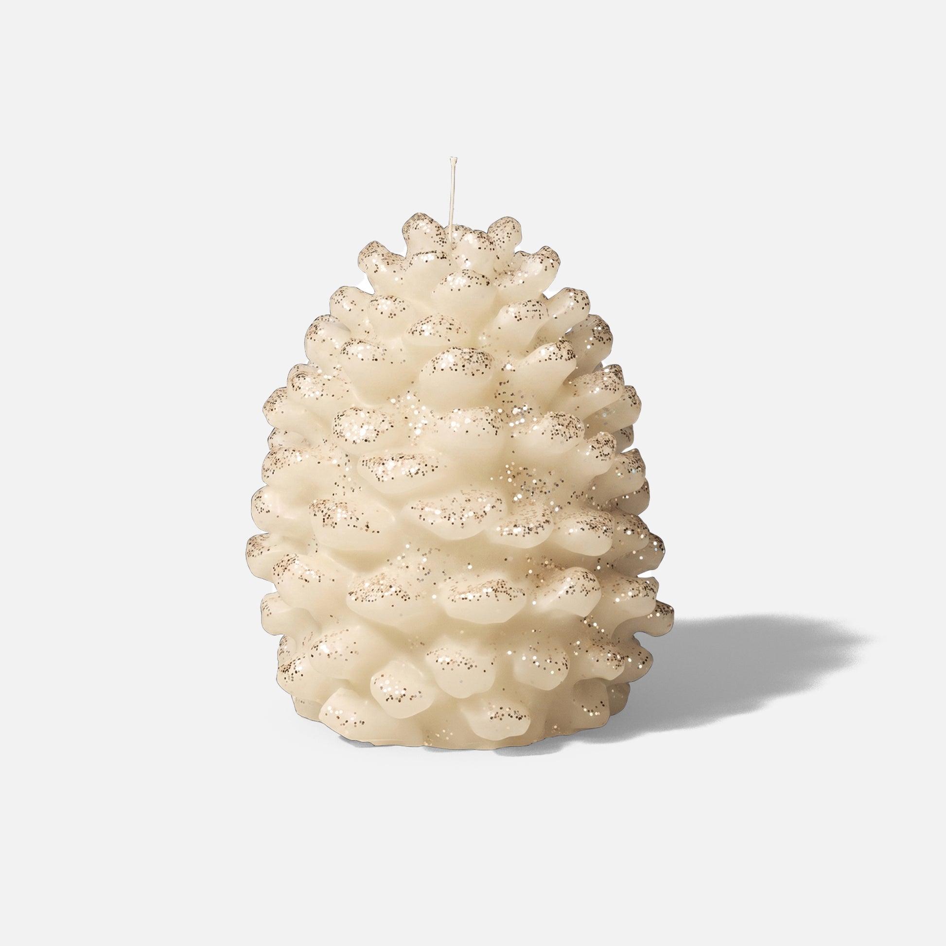 Cream glitter dust winter pinecone pillar candle plain white background product shot - Boowan Nicole