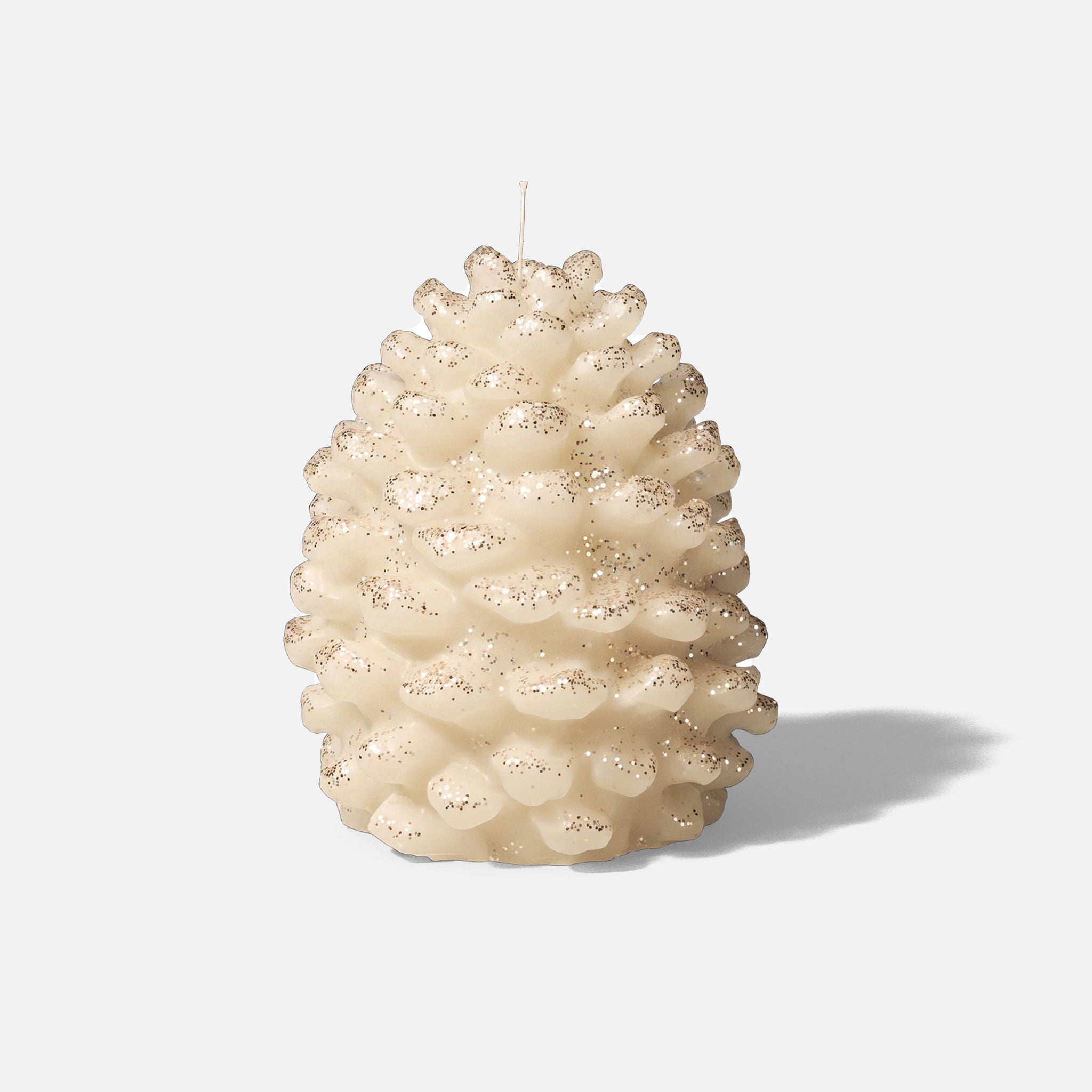 Cream glitter dust winter pinecone pillar candle plain white background product shot - Boowan Nicole