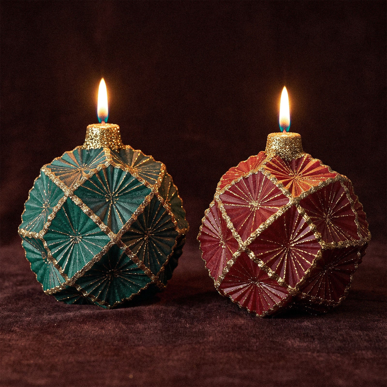 Lit green and burgundy geometric ornament‑shaped Christmas ball candles on dark velvet background - Boowan Nicole