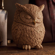 Close‑up shot of gilded finished owl candle jar with detailed feather textures and golden trim - Boowan Nicole