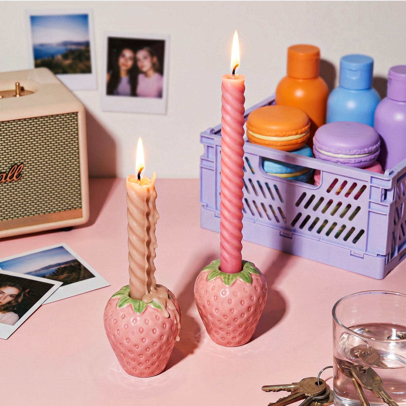 Lit Twist Taper Candles in Strawberry-Shaped Holders on Pink Desk - Boowan Nicole