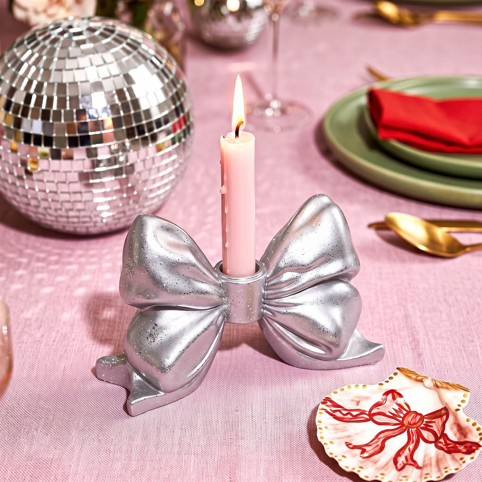 Silver bow taper candle holder with lit pink candle, dinner table styling with disco ball - Boowan Nicole