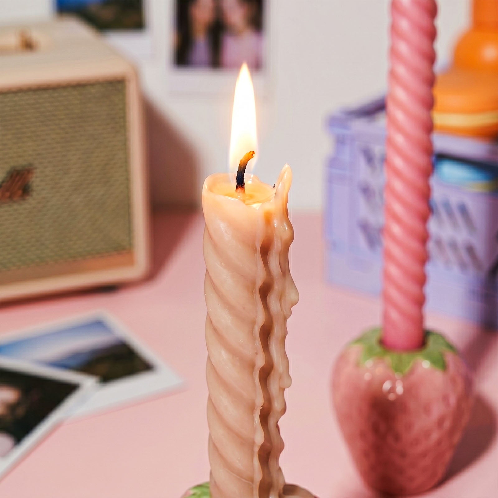 Close-up of Lit Nude Twist Taper Candle with Wax Drips - Boowan Nicole
