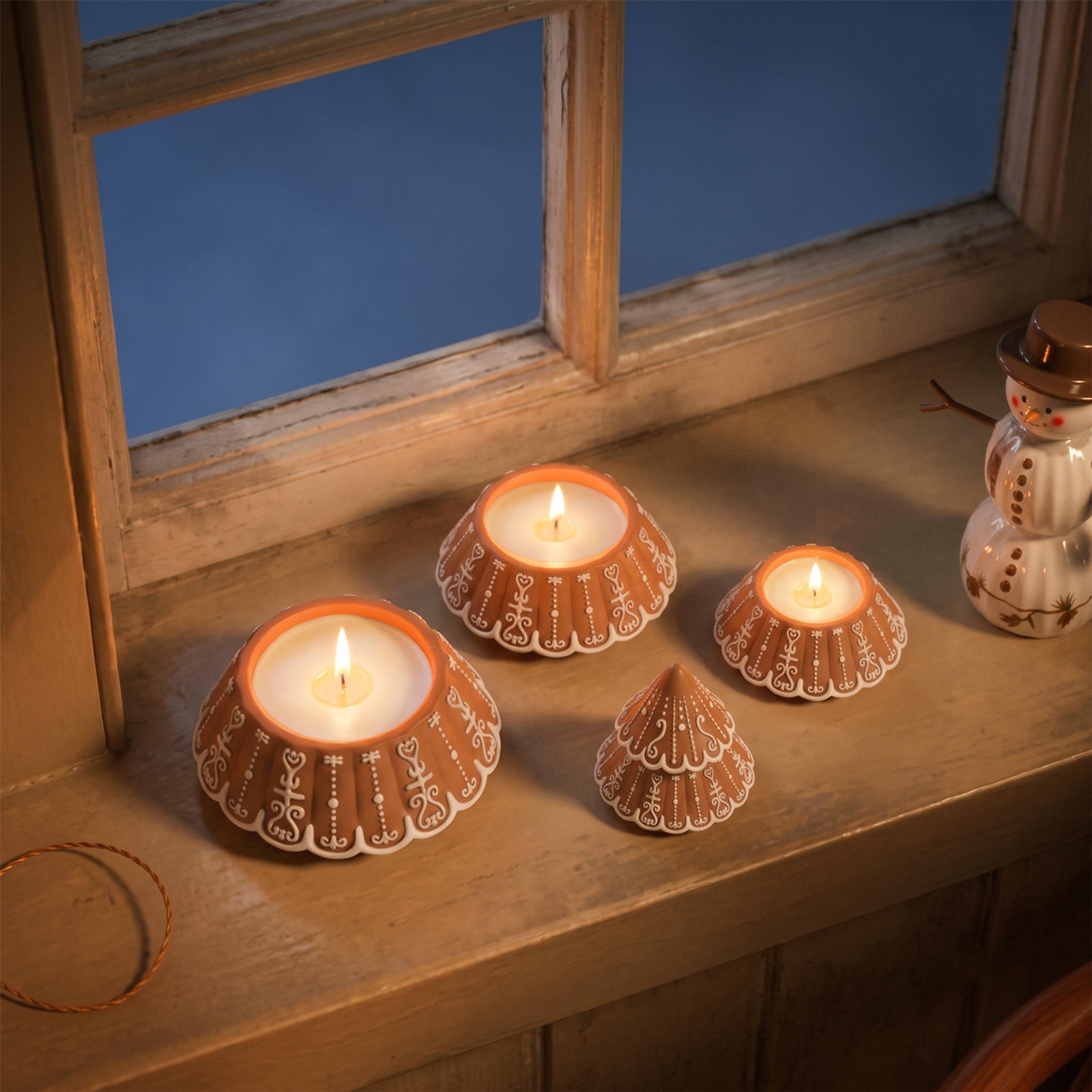 Unlit gingerbread pattern stacking tree candle jars set on rustic windowsill holiday decor - Boowan Nicole