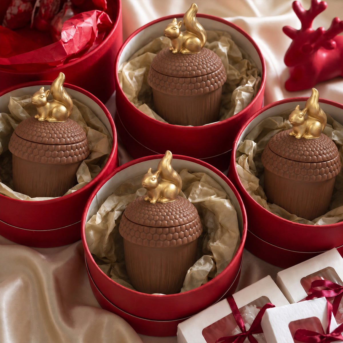 Four handmade acorn squirrel candle jars neatly packed inside red gift boxes with tissue paper, perfect autumn holiday gift set - Boowan Nicole