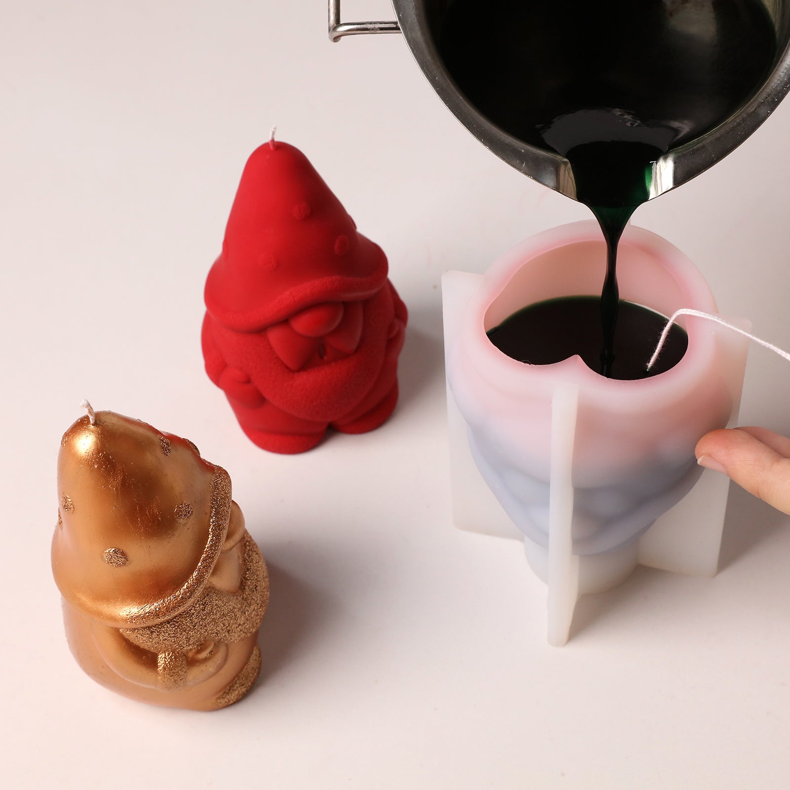 DIY candle making, pouring melted green wax into gnome silicone candle mold - Boowan Nicole