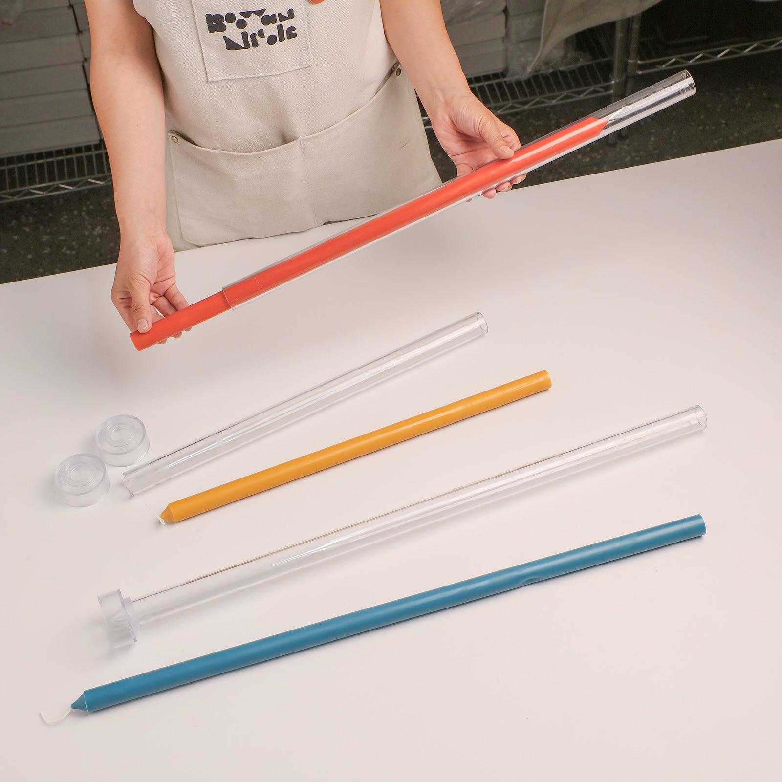 Unmolding Finished Orange Tall Slim Taper Candle from Clear Acrylic Mold - Boowan Nicole
