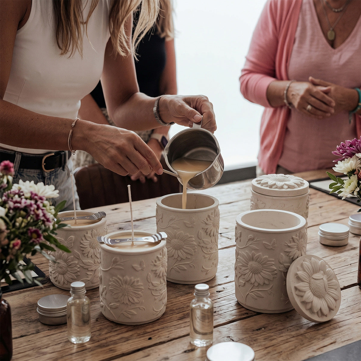 Sunflower Embossed Candle Jar Silicone Mold, pouring melted wax into finished candle jars during workshop - Boowan Nicole