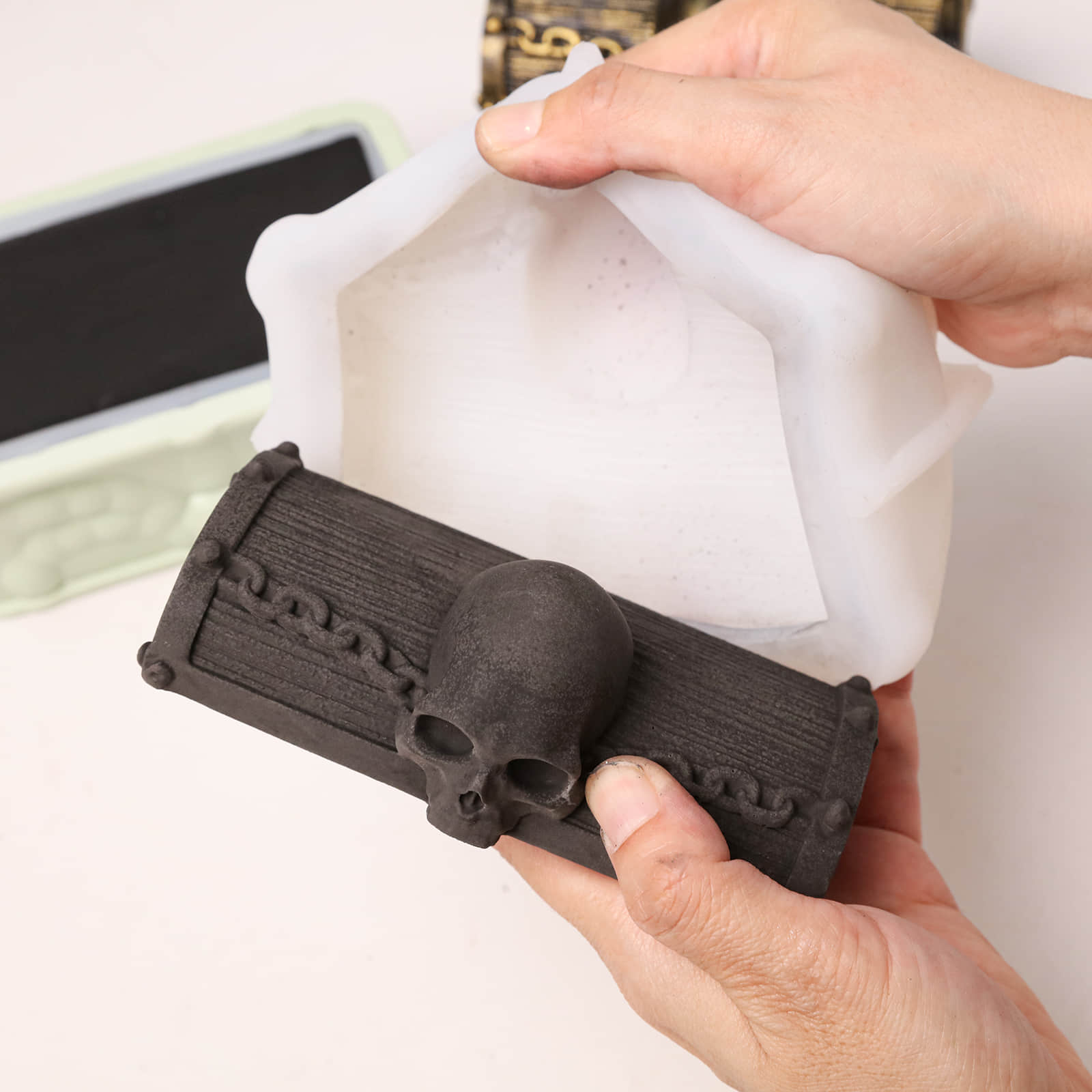 Demolding raw black skull treasure chest craft piece from flexible silicone mold - Boowan Nicole