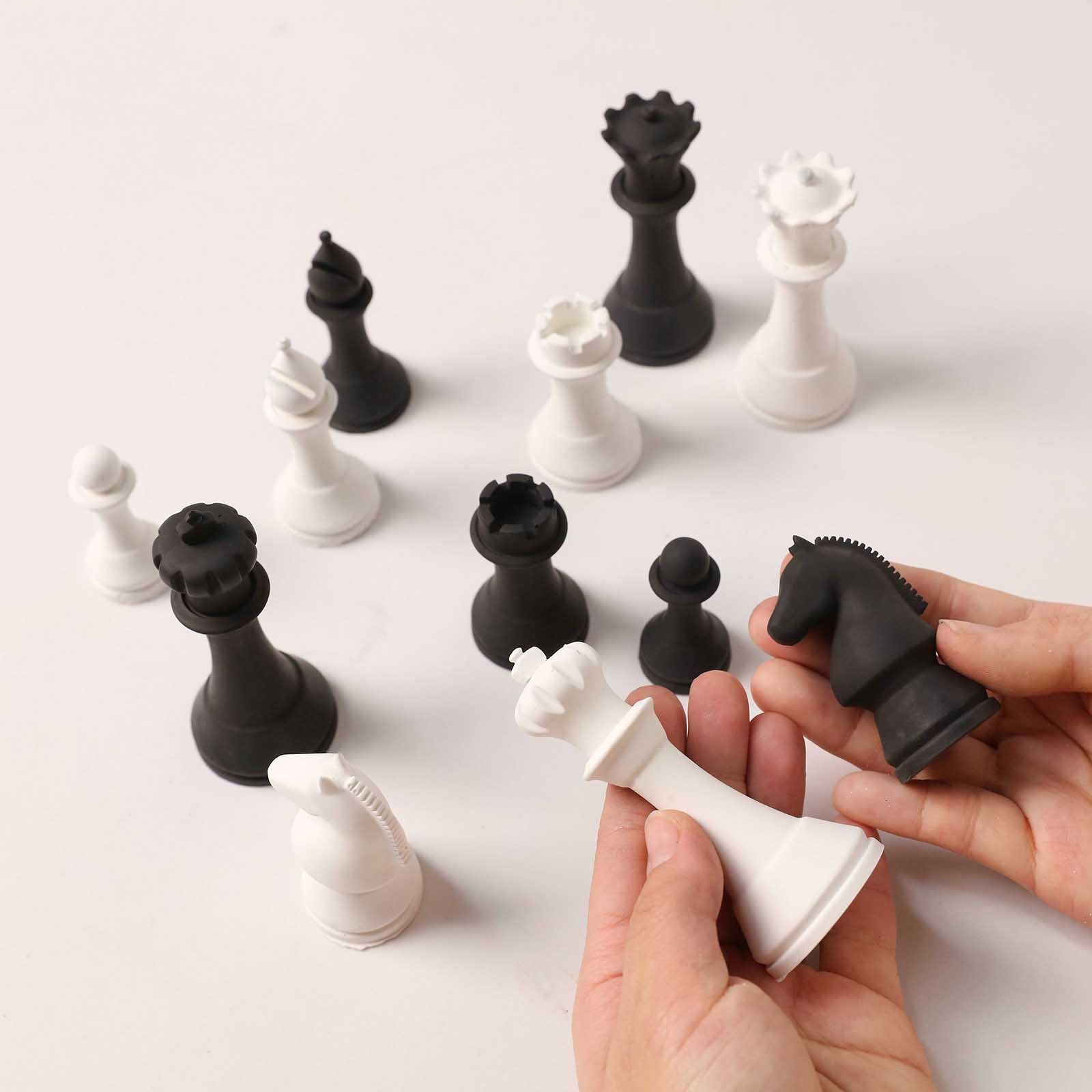 Black and White Finished Chess Pieces Held in Hands - Boowan Nicole