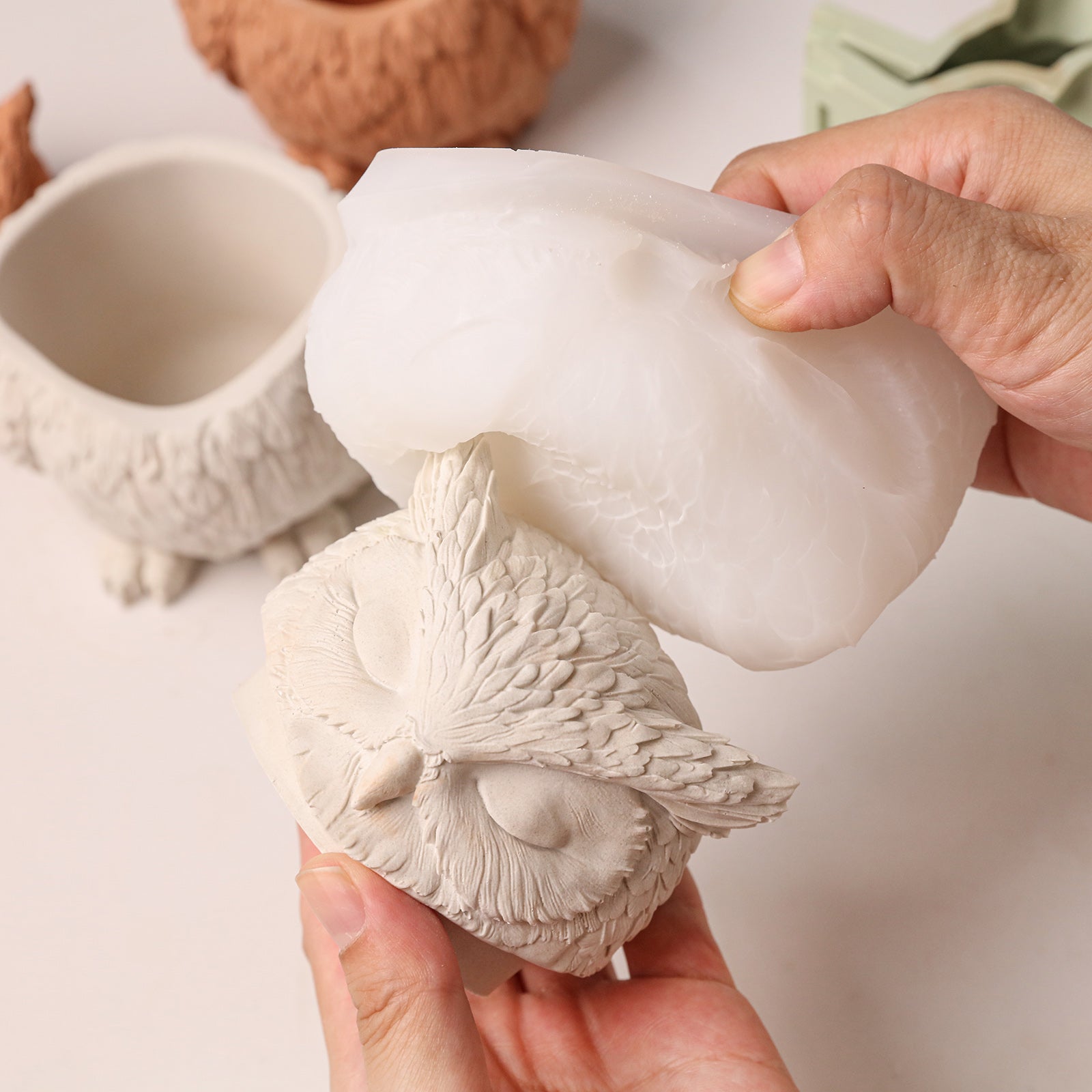 Demolding process, taking detailed owl head piece out from soft silicone mold - Boowan Nicole