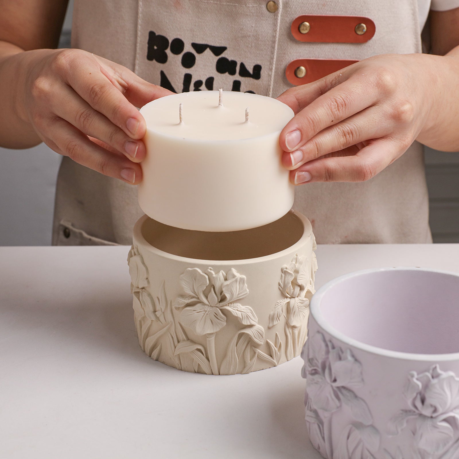 Iris Embossed Candle Jar Silicone Mold, placing candle into finished beige candle jar - Boowan Nicole