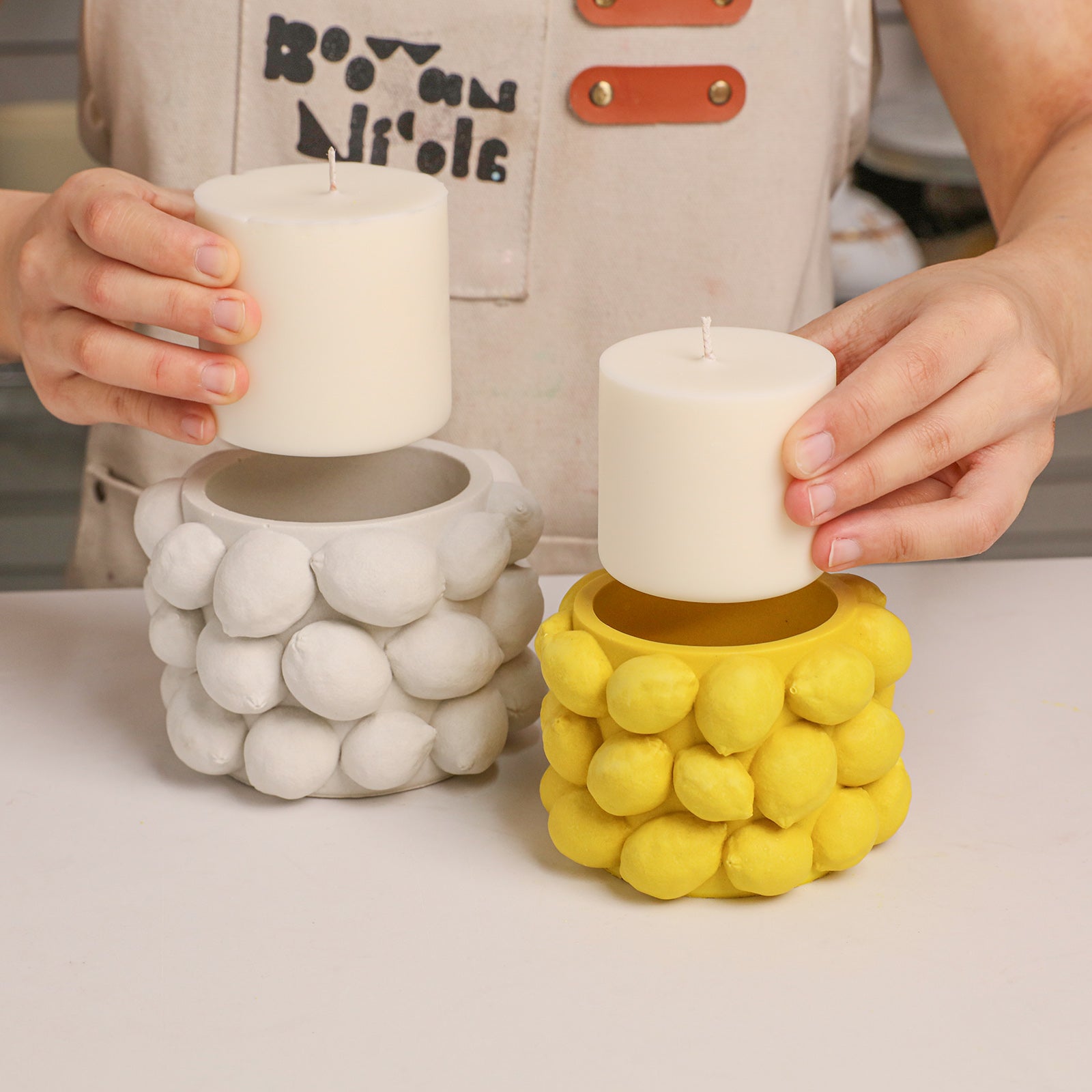 Display refillable design of Lemon Drops candle jars with separate pillar candles - Boowan Nicole