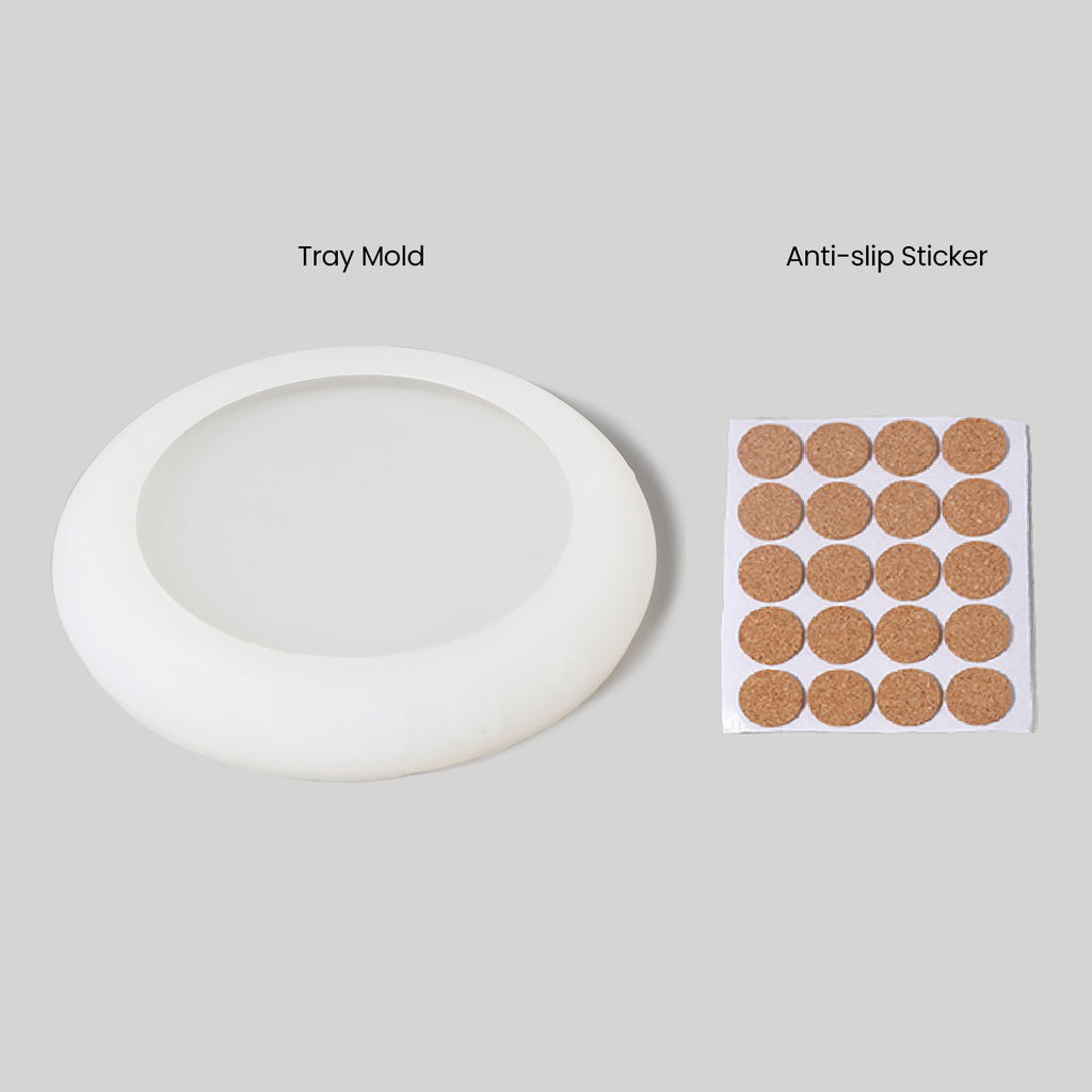A silicone mold for making trays and twenty non-slip round pads.
