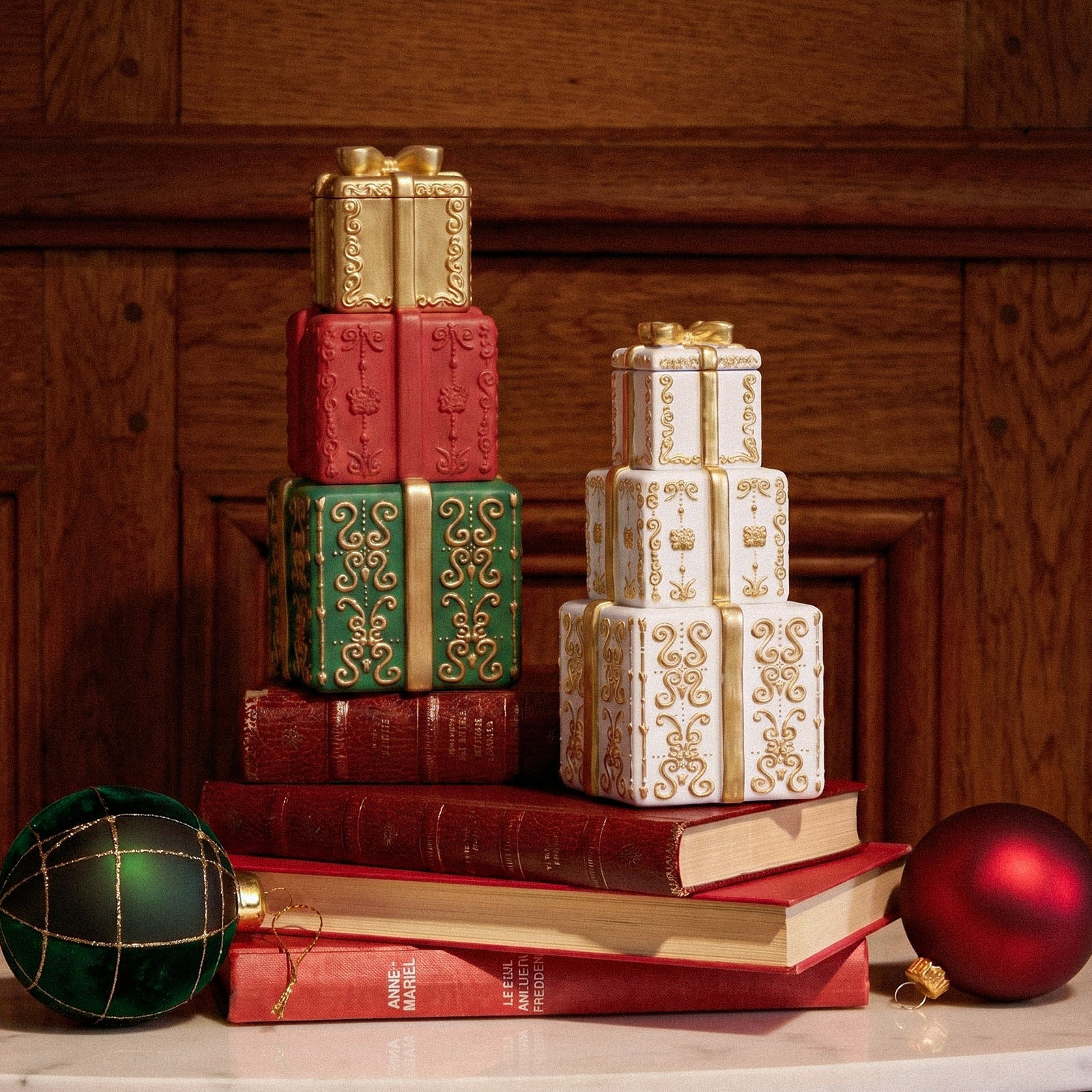 Two sets of stacked embossed gift box candle jars arranged on vintage books festive interior - Boowan Nicole