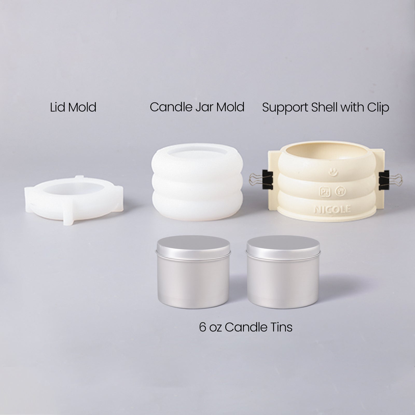 A silicone mold set for making candle jars and two aluminum jars for making candle refills.