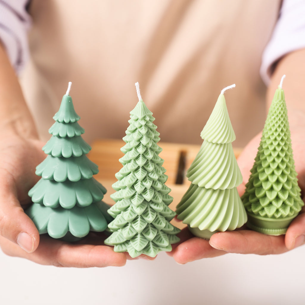 Four Christmas tree-shaped candles with different shapes are displayed in your hands.