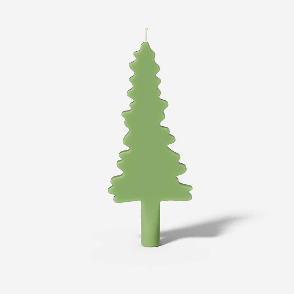 Christmas evergreen tree silhouette taper candle made from silicone mold for holiday decoration.