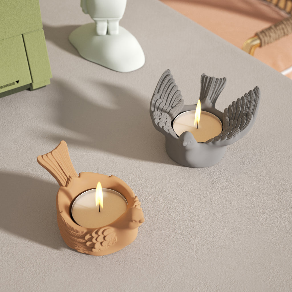 Illumination in progress—the candles within yellow, wing-closed and grey, wing-opened bird-shaped tea light holders are being ignited.