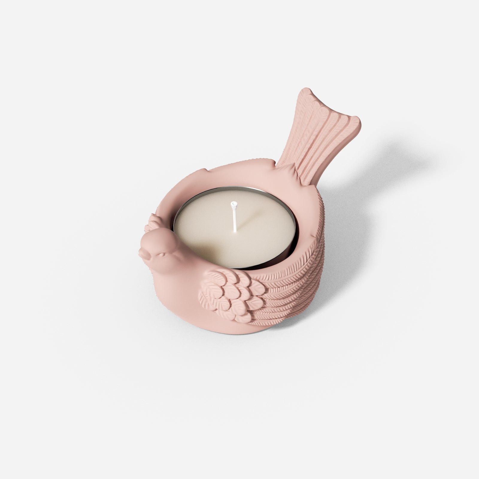 A Joyful Bliss Bird Tealight Candle Holder with a lit tealight candle.