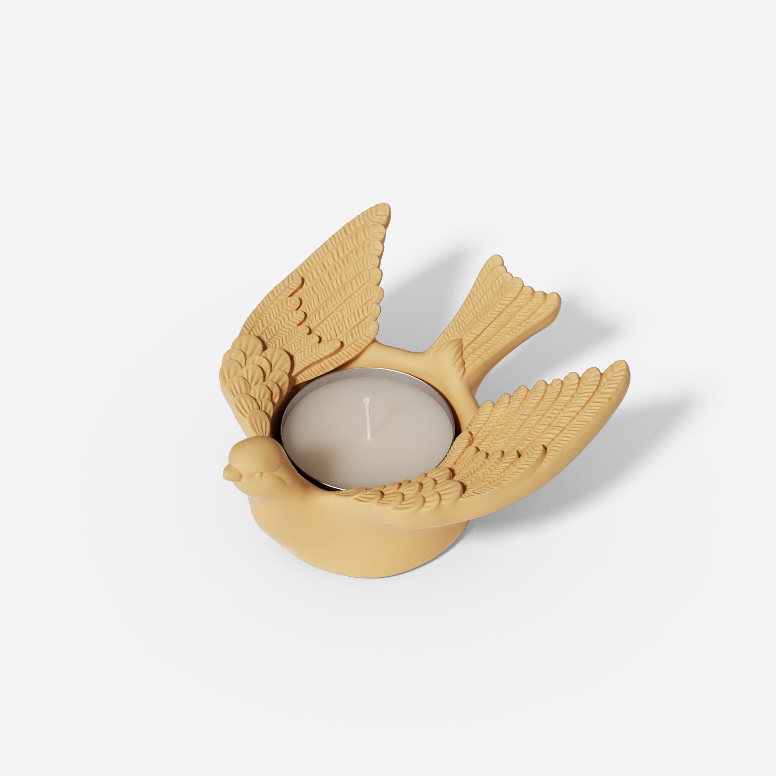 A Joyful Bliss Bird Tealight Candle Holder with wings spread open.