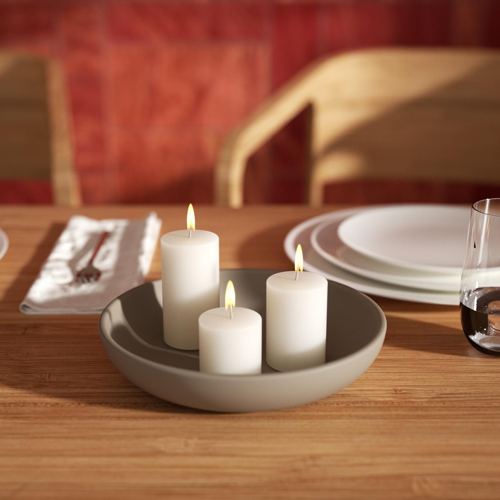 Lighted candles are placed in trays made using silicone molds.