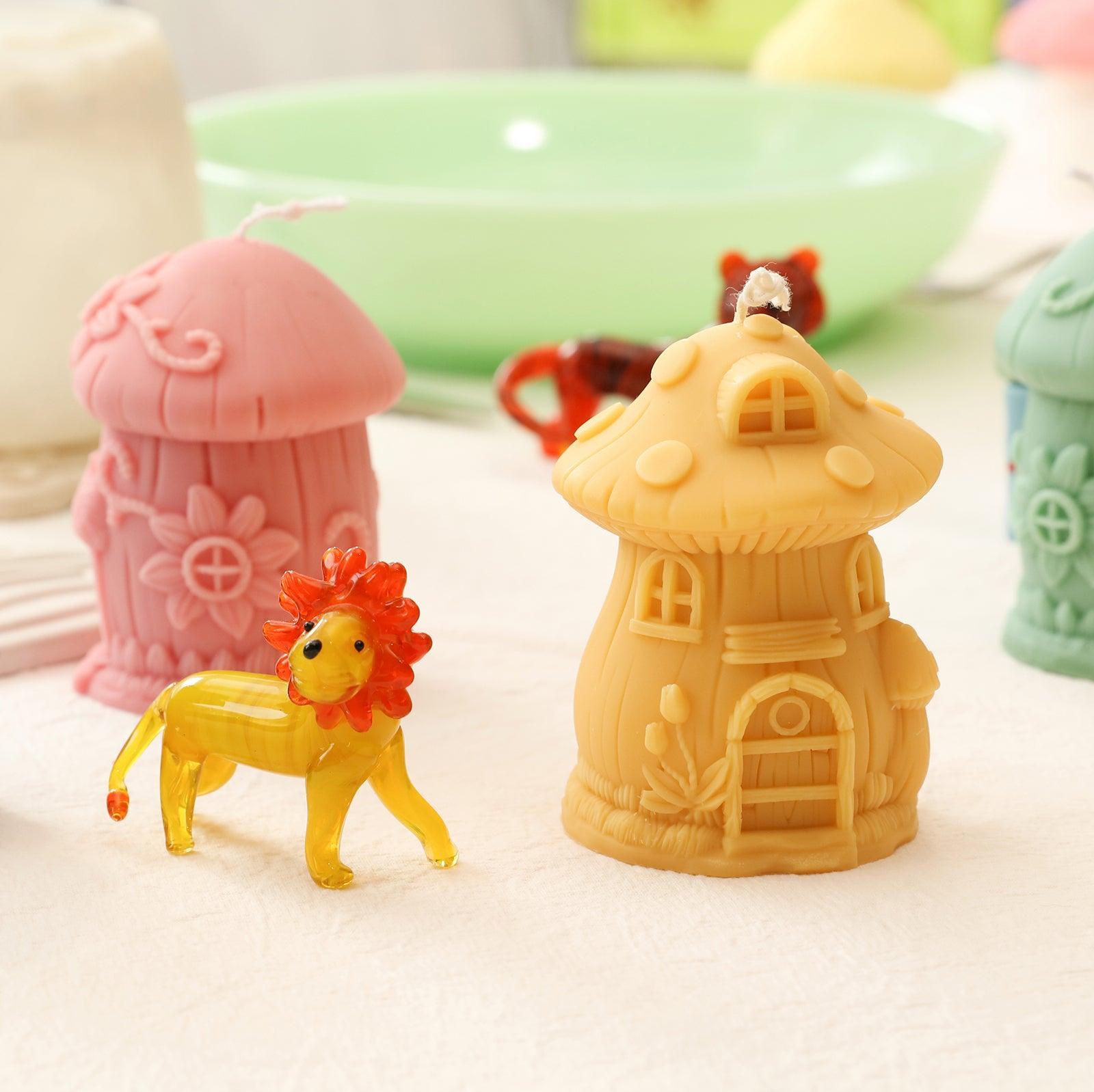 Yellow and pink mushroom house-shaped candles made using silicone molds, designed by Boowan Nicole.