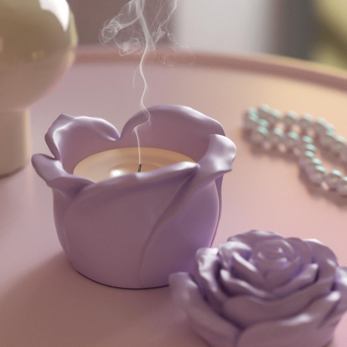 Purple rose-shaped candle jar with extinguished smoke on a pink table - Boowan Nicole