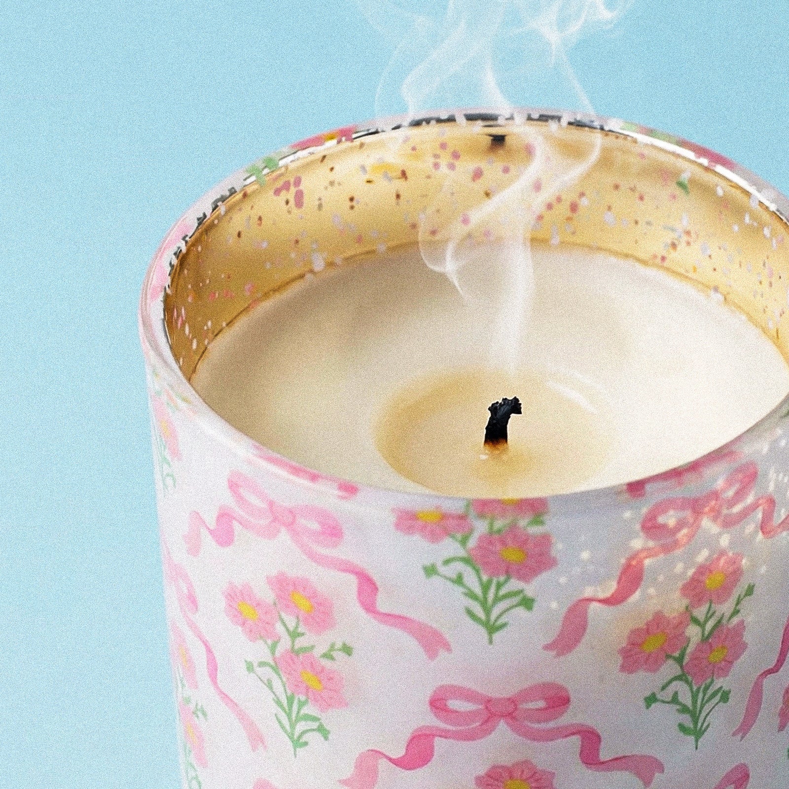 Close-up of Smoldered Wick on Pink Ribbon & Wild Daisy Graphic Gold Speckled Rim Glass Candle Vessel - Boowan Nicole