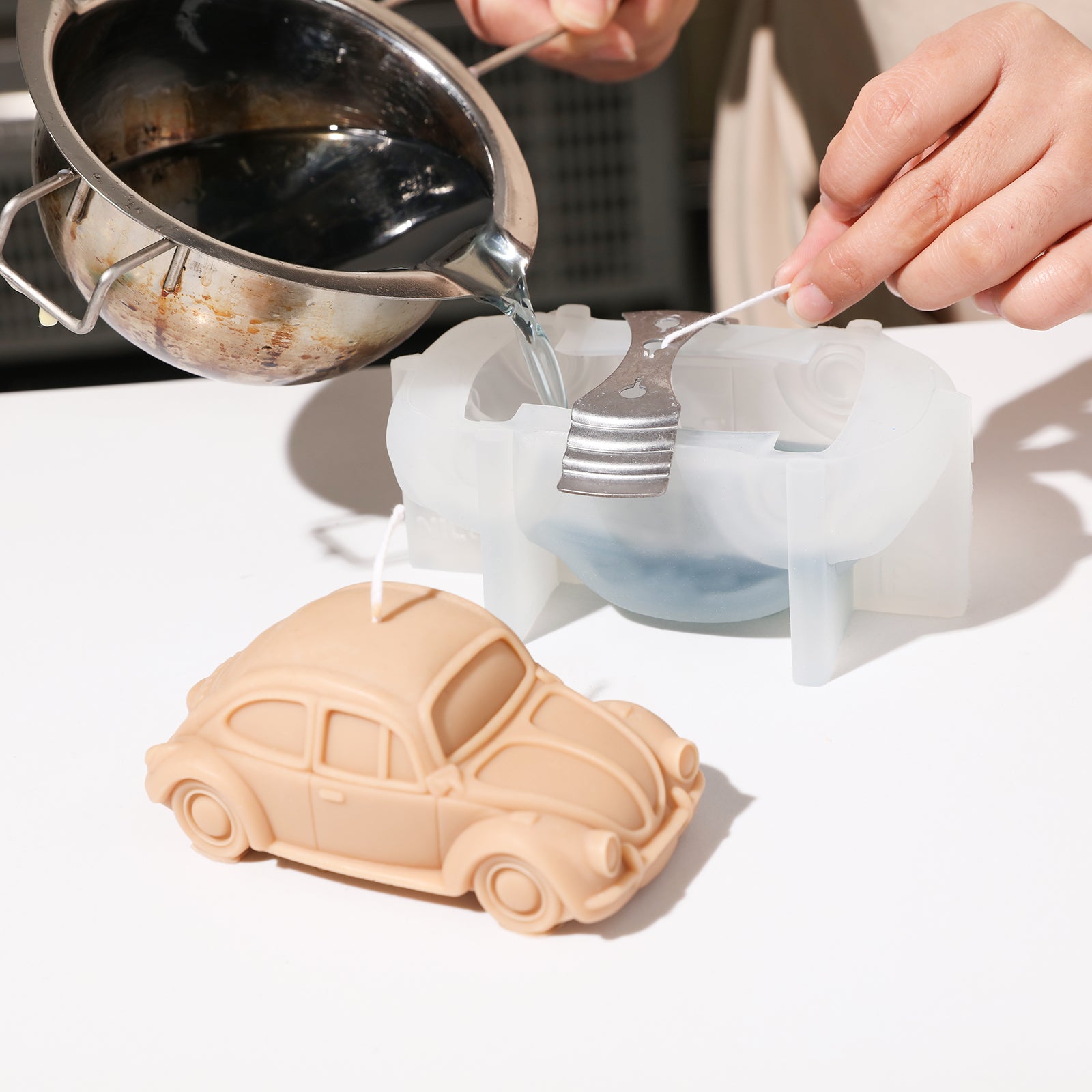  Crafting car candles using the candle mold for creative joy.