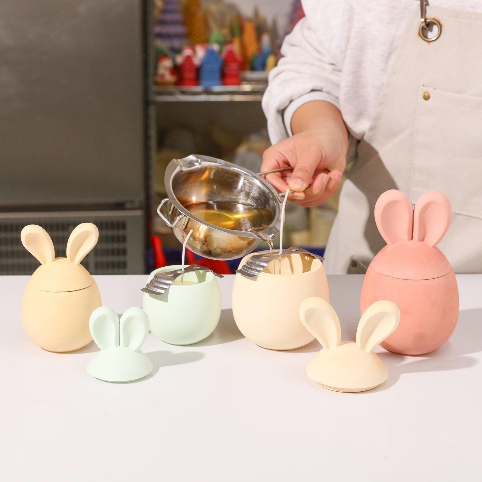 Pouring wax into the candle jar to make a candle