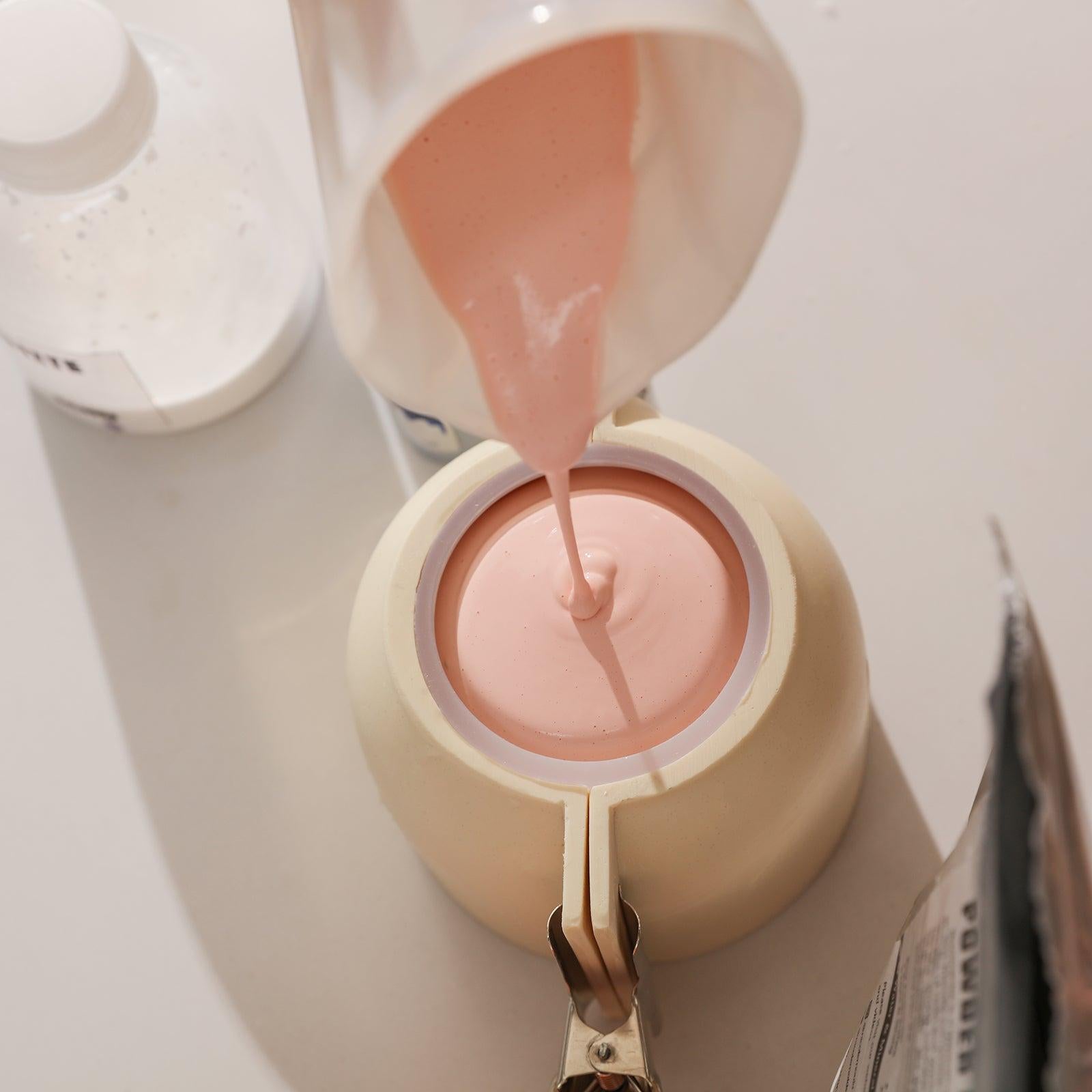 Pour Boowannite into silicone molds to create face candle jars - Boowan Nicole