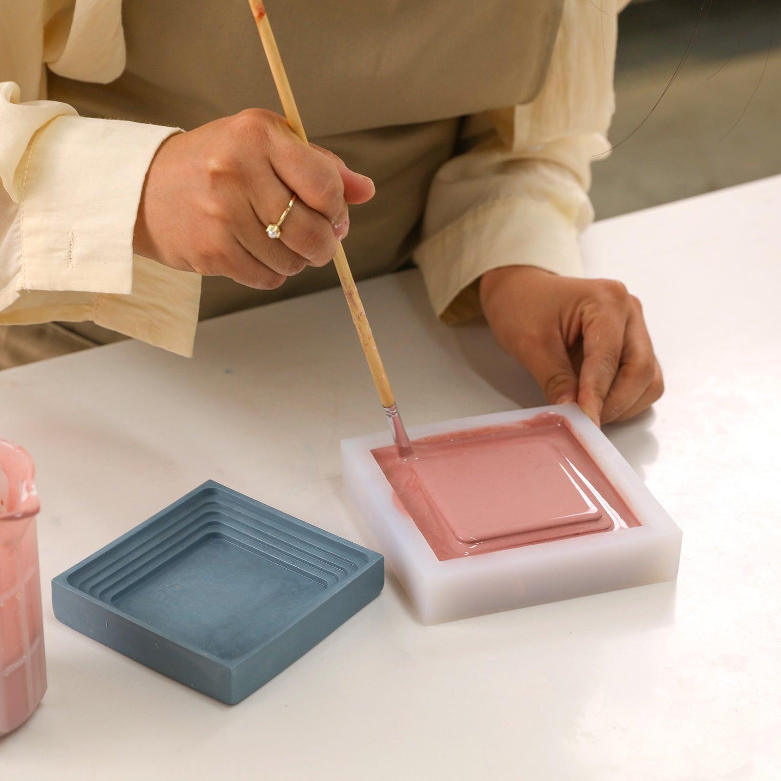 Expel bubbles from the boowannite material in the white silicone mold to make Square Large Desk Caddy-Boowan Nicole