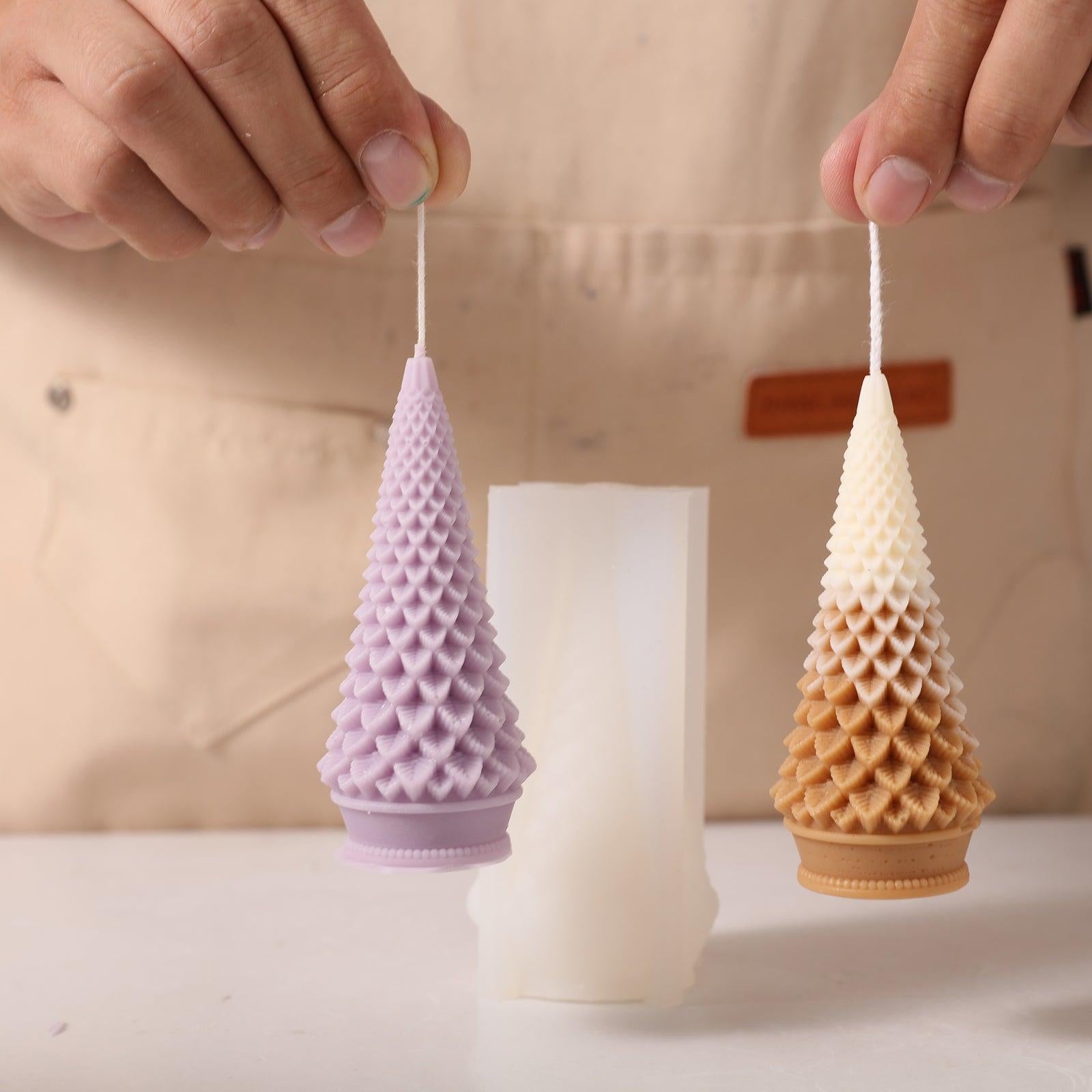 Holding two Christmas tree candles showing wicks - Boowan Nicole