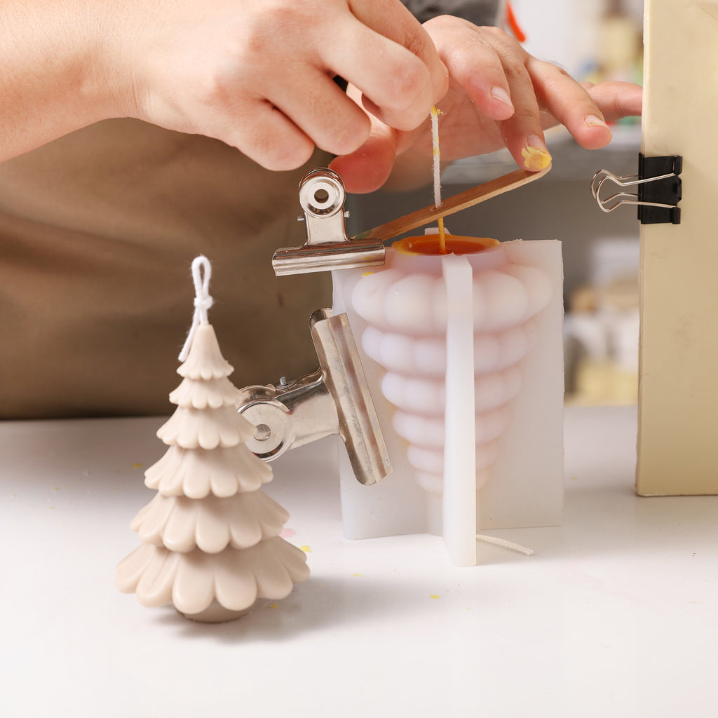 Use silicone molds to create 4-inch Christmas tree candles, designed by Boowan Nicole.