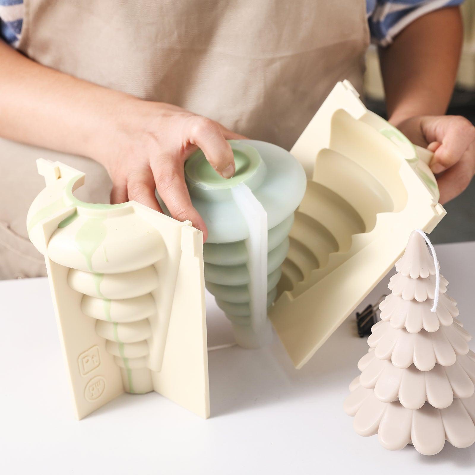 The plastic support casing used to make the Christmas tree candles is removed and ready for demolding, designed by Boowan Nicole.