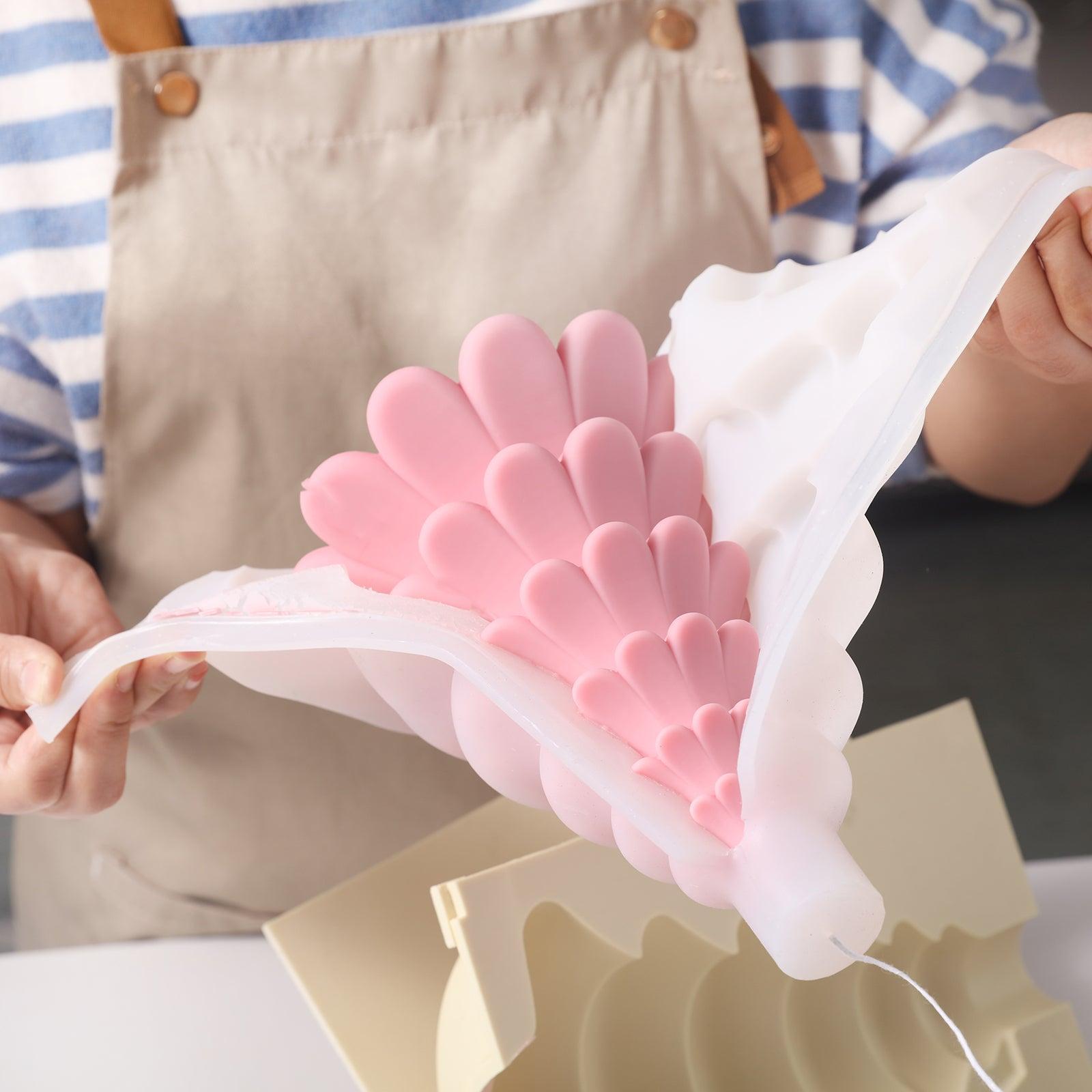 Pink layered Christmas tree candles from white silicone molds, designed by Boowan Nicole.